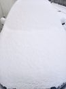 Car snowed under after abundant snowfall parked in city