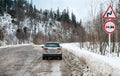 Krasnodar region, Russia February 3, 2020. Volkswagen Tiguan on a snowy dirt road in the mountains and warning signs