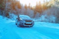 A car on a snowy mountain road. The concept of traveling and driving in winter conditions Royalty Free Stock Photo