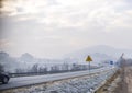 Car in snowy road with frozen sign