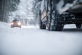 Car on a snowy winter road amid forests