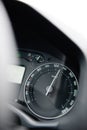 Car speedometer close-up with the needle pointing a high 130 km/mph speed,