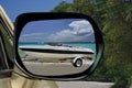 Car & speedy boat on paradise beach. Royalty Free Stock Photo