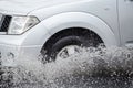 Car splashes through a large puddle on a flooded street Royalty Free Stock Photo