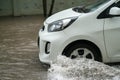 Car splashes through a large puddle on a flooded street Royalty Free Stock Photo