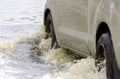 Car splashes through a large puddle on a flooded street Royalty Free Stock Photo