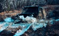 A car sprays mud. 4x4 off-road suv car stuck in mud. Racer at terrain racing car competition. Off-road vehicle goes on Royalty Free Stock Photo