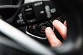 Car start stop system with finger pressing the button. Car driver starting the engine keyless. Royalty Free Stock Photo
