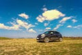 car stopped in the desert at night under the moonlight with stars and clouds in the sky, dasht e lut or sahara desert Royalty Free Stock Photo