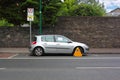 Car street clamped with metal wheel clamp Royalty Free Stock Photo