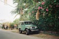 Car on the street parked near the flowers garden