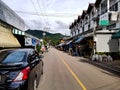 Car street road electricity cable mast houses village pai middle centre shops walking north chiang mai mountain green
