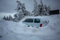 Car stuck in deep snow on mountain road - winter traffic problem Royalty Free Stock Photo