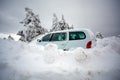 Car stuck in deep snow on mountain road - winter traffic problem Royalty Free Stock Photo