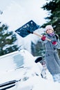 Car Stuck in the snow and a Woman Shoveling Royalty Free Stock Photo