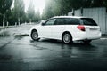 Car Subaru Legacy stay on asphalt road and reflected in puddle in the city at daytime Royalty Free Stock Photo