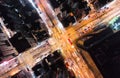 Car, taxi, and bus traffic on road intersection at night in Hong Kong downtown district, drone aerial top view. Asia city life