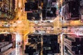 Car, taxi, and bus traffic on road intersection at night in Hong Kong downtown district, drone aerial top view. Asia city life Royalty Free Stock Photo