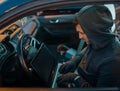 Car thief with laptop hacking security system Royalty Free Stock Photo