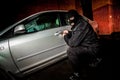 Car thief in a mask. Royalty Free Stock Photo
