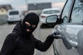 Car thief pulls the handle of a car. Royalty Free Stock Photo