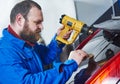 Car tinting. Automobile mechanic technician applying foil Royalty Free Stock Photo