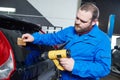 Car tinting. Automobile mechanic technician applying foil Royalty Free Stock Photo