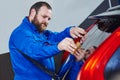 Car tinting. Automobile mechanic technician applying foil Royalty Free Stock Photo