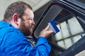 Car tinting. Automobile mechanic technician applying foil