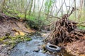 Car tire in a creek in a ravine