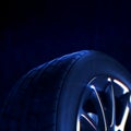 Car tire with depth of field blur on black background. Selective focus. Royalty Free Stock Photo