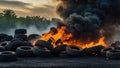 Car tire dump, tire storage yard fire, black smoke rising from the dump Royalty Free Stock Photo