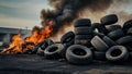 Car tire dump, tire storage yard fire, black smoke rising from the dump Royalty Free Stock Photo