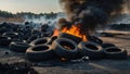 Car tire dump, tire storage yard fire, black smoke rising from the dump Royalty Free Stock Photo