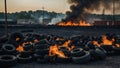 Car tire dump, tire storage yard fire, black smoke rising from the dump Royalty Free Stock Photo