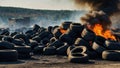 Car tire dump, tire storage yard fire, black smoke rising from the dump Royalty Free Stock Photo