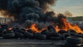 Car tire dump, tire storage yard fire, black smoke rising from the dump Royalty Free Stock Photo