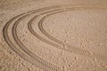 Car tire footprint and wheel track on sand in desert beach on fine sand of desert dune Royalty Free Stock Photo