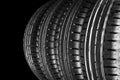 Car tire isolated on black background. Tire stack. Car tyre protector close up. Black rubber tire. Brand new car tires. Close up b Royalty Free Stock Photo
