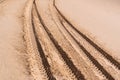 Car tire marks in the sand. Car tracks on desert Royalty Free Stock Photo