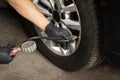 Car tire pressure check using air pressure guage. Mechanic inflating a car tire. Gas pumping of a car wheel. Car tire Royalty Free Stock Photo