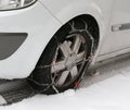 Car tire with snow chains in winter Royalty Free Stock Photo