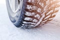 The car tire in the snow close up. Car tracks on the snow. Traces of the car in the snow. Winter tires. Tyres covered with snow at Royalty Free Stock Photo