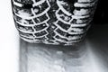 The car tire in the snow close up. Car tracks on the snow. Traces of the car in the snow. Winter tires. Tyres covered with snow at Royalty Free Stock Photo