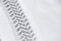 Car tire tracks in fresh snow on the road. Snowfall. Royalty Free Stock Photo