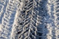 Car tire tracks. Snowy and icy road, dangerous and unsafe. Winter morning