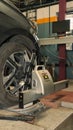 a car tire under maintenance and correction of steering angles