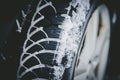 Car tire in winter on the road covered with snow, close up picture