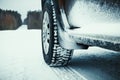 Car tires covered with snow on winter road. Royalty Free Stock Photo