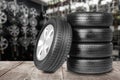 Car tires on wooden surface in auto store Royalty Free Stock Photo